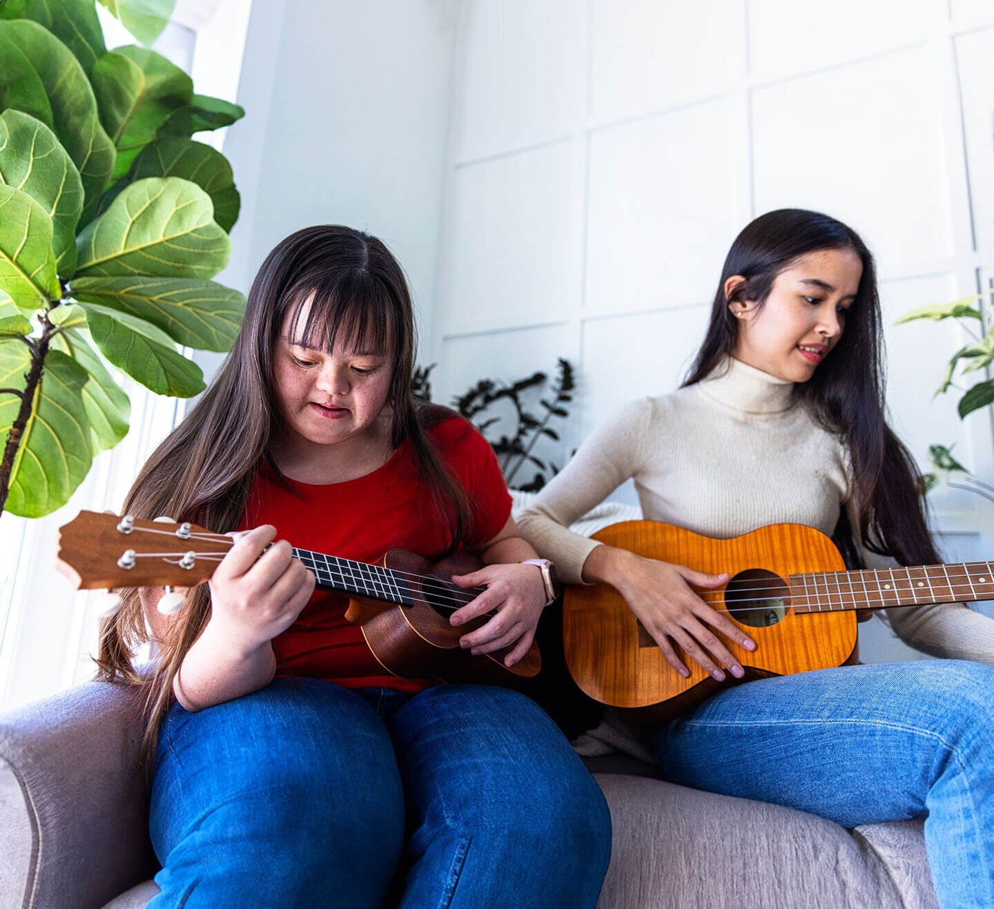 A participant and mentor playing music together